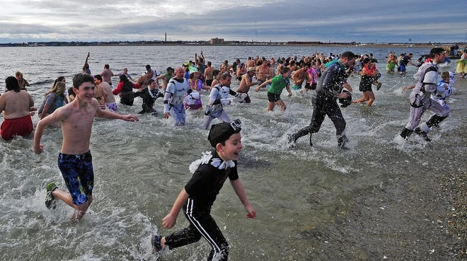 Hale and hardy bathers exit the water after taking a plunge at Fort Phoenix in Fairhaven last year. Plunging into the icy ocean is one way to shake the cobwebs and greet the new year. DAVID W. OLIVEIRA / STANDARD-TIMES FILE PHOTO/SCMG