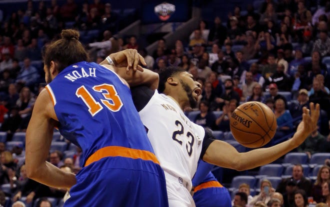 Pelicans' Anthony Davis (23) gets tangled up with Knicks' Joakim Noah as they go for a rebound during the first half Friday night in New Orleans. The Associated Press