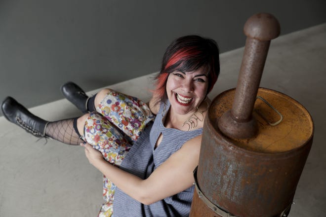 AP PHOTO/CHRIS CARLSON Amber Clisura poses for a picture next to the meat smoker she donated to the new Museum of Broken Relationships in Los Angeles.