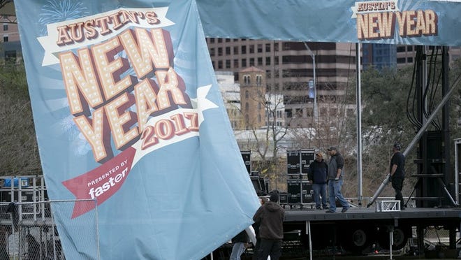 Crews spent Friday setting up one of four stages for Austin’s New Year’s Eve celebration on Vic Mathias Shores. DEBORAH CANNON / AMERICAN-STATESMAN