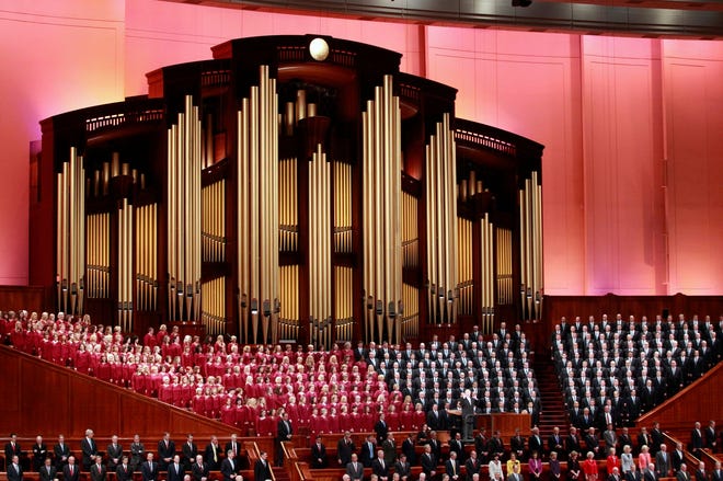 FILE - In this Oct. 1, 2016, file photo, the Mormon Tabernacle Choir of The Church of Jesus Christ of Latter-day Saints, sings in the Conference Center at the morning session of the two-day Mormon church conference in Salt Lake City. Choir member Jan Chamberlin posted a resignation letter that she says she sent to choir leaders on her Facebook page Thursdaym Dec. 29, 2016. In it, she writes that by performing at the inaugural, the 360-member Choir will appear to be “endorsing tyranny and facism” and says she feels “betrayed” by the choir’s decision to take part. (AP Photo/George Frey, File)