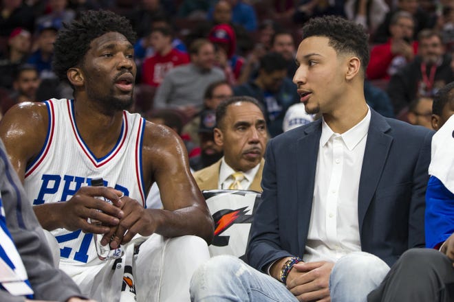 (File) Sixers rookie center Joel Embiid (left) chats with injured rookie Ben Simmons during a Dec. 14 loss to the Raptors.
