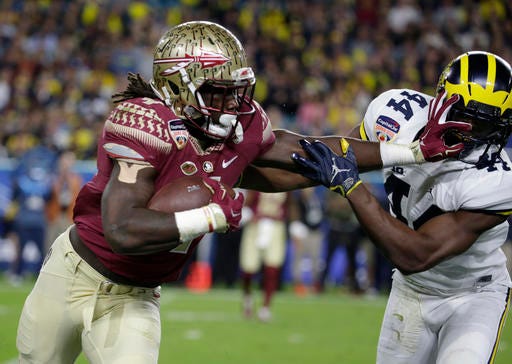 Michigan safety Delano Hill (44) attempts to stop Florida State running back Dalvin Cook (4, during the first half of the Orange Bowl NCAA college football game, Friday, Dec. 30, 2016, in Miami Gardens, Fla. (AP Photo/Lynne Sladky)