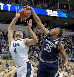Notre Dame forward Bonzie Colson (35) blocks a shot by Pittsburgh forward Ryan Luther (4) during the first half of an NCAA college basketball game, Saturday, Dec. 31, 2016, in Pittsburgh. (AP Photo/Fred Vuich)