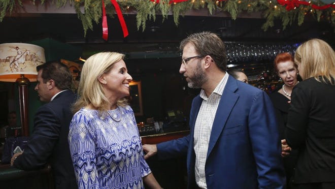 Andrew Wetenhall, new owner of The Colony, talks with Carol Anderson at a reception Wednesday at The Colony’s Polo Lounge. Members of the Wetenhall family bought the property. (Yuting Jiang / Daily News)