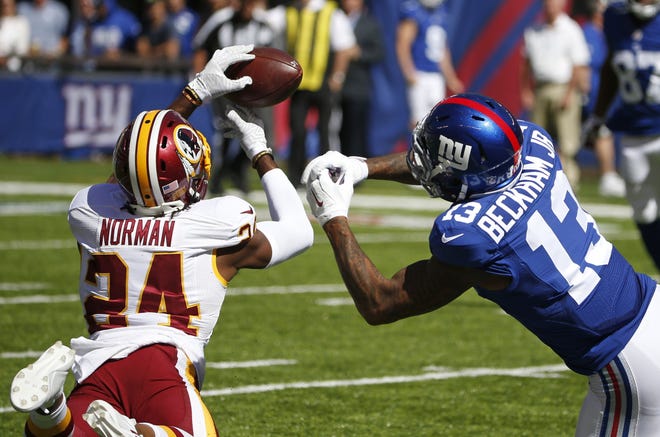Washington Redskins cornerback Josh Norman (24) gets his hands on a pass intended for the Giants' Odell Beckham Jr. during the teams' first matchup on Sept. 25. The Redskins won that sloppy game, 29-27, and need to beat the Giants again — and hope the Green Bay-Detroit game doesn't end in a tie — to clinch an NFC playoff berth. The Associated Press