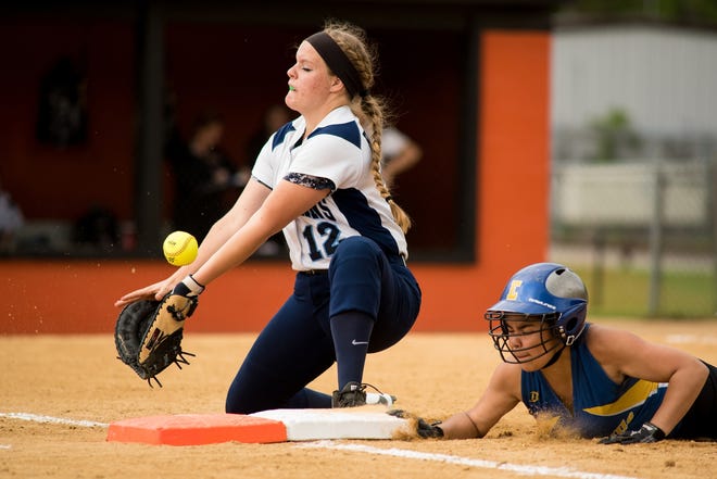 Ellenville's Jasmine Robles slides into first base as Pine Plains's Catie Gomm misses the ball during the Ellenville High School versus Pine Plains softball game at Marlboro High School on May 17. KELLY MARSH/FOR THE TIMES HERALD-RECORD