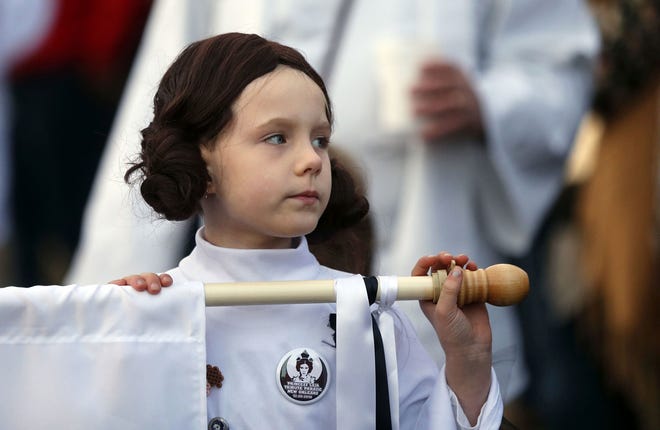 Addy Longlois, 7, dressed as Princess Leia, walks in a parade in honor of actress Carrie Fisher, who played Princess Leia in the "Star Wars" movie series, in New Orleans, Friday, Dec. 30, 2016. Fisher died on Dec. 27, 2016, at the age of 60. The parade was held by the Krewe of Chewbacchus, a "Star Wars" themed Mardi Gras Krewe. (AP Photo/Gerald Herbert)