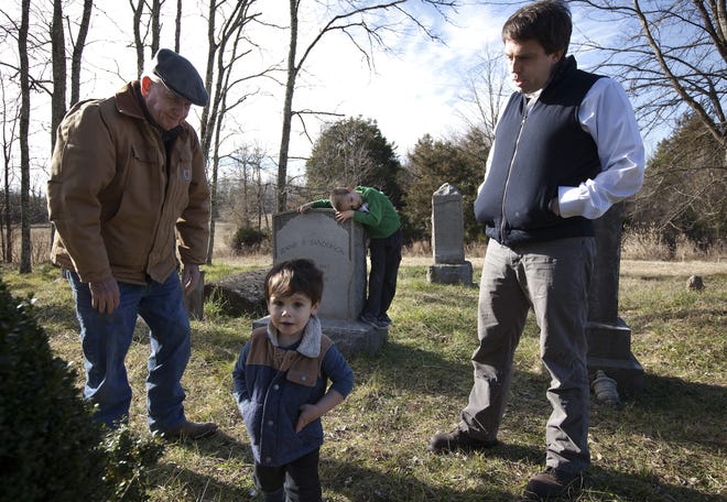John Sanderson, left, watches grandsons, Luke Pollard Sanderson, 2, and Clinton Sanderson Pancho, 6, with his son, Bill, at their private cemetery in Cartersville, Va. Family cemeteries, a relic of another age, receive nonprofit status from the Internal Revenue Service. THE NEW YORK TIMES / KHUE BUI
