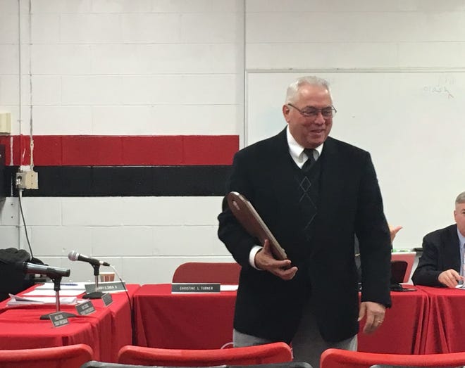 Cinnaminson Board of Education member Harry Shea III receives a plaque at the Dec. 20 meeting for his years of service.