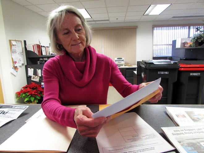 SHARON WOODS HARRIS / GATEHOUSE MEDIA ILLINOIS Pekin City Clerk Sue McMillon opens a Request for Proposals for city corporation counsel from Elliff, Dancey & Bosich, P.C., on Thursday afternoon. It was the only proposal submitted.