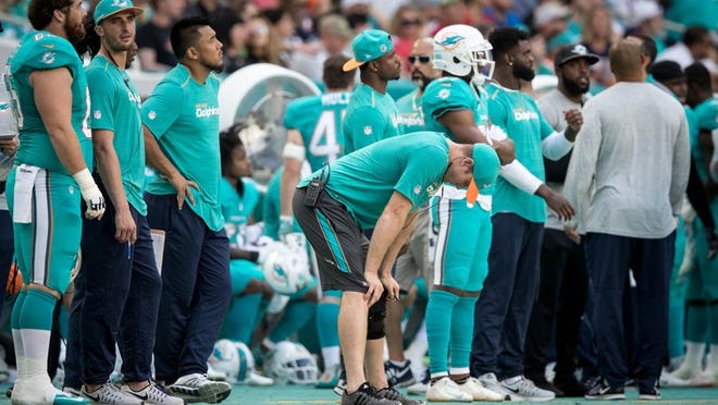 Miami Dolphins quarterback Ryan Tannehill (17) hangs his head as the Patriots take a three touchdown lead late in the fourth quarter at Hard Rock Stadium in Miami Gardens, Florida on January 1, 2017. (Allen Eyestone / The Palm Beach Post)