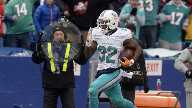 Miami Dolphins running back Kenyan Drake (32) runs for a touchdown during the first half of an NFL football game Saturday, Dec. 24, 2016, in Orchard Park, N.Y. (AP Photo/Adrian Kraus)