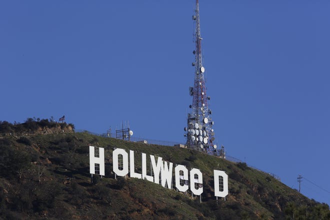 Los Angeles residents awoke New Year's Day to find a prankster had altered the famed Hollywood sign to read "HOLLYWeeD." (AP Photo/Damian Dovarganes)