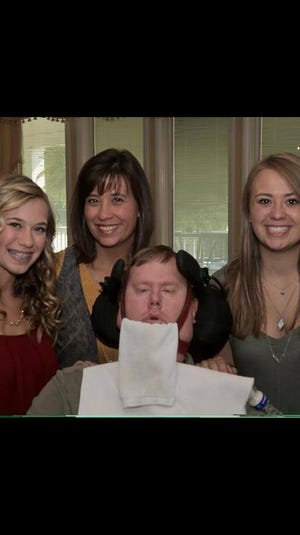 David Wilson is shown with his wife Sharon and two daughters, Katie and Gracie. Wilson died Thursday at the age of 47 after a nine-year battle with ALS. After his diagnosis, Wilson and his family gave back to the community with their annual "Pass the Gift" fundraiser.

Photo courtesy the Wilson family