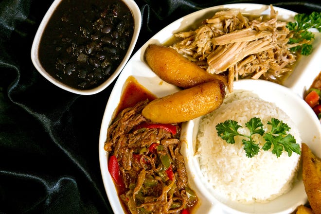 Omi's Tavern, a South American/Caribbean restaurant in the Sun Center downtown, offers such dishes as the "Four Cubans," a platter of Cuban delicacies that includes mojo pork, chicken cilantro, ropa vieja and picadillo served with black beans, rice and plaintains. (Alan Youngblood/Staff photographer/file)