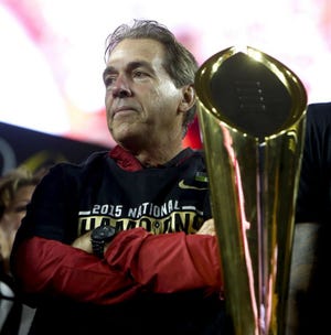 Coach Nick Saban waits beside the championship trophy after Alabama's win over Clemson in the College Football Playoff National Championship game in the University of Phoenix Stadium Monday, January 11, 2016. Staff Photo | Gary Cosby Jr.