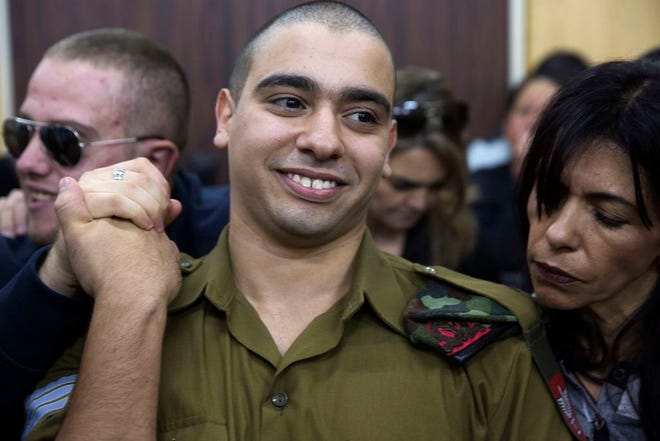 Israeli solider Sgt. Elor Azaria waits with his parents for the verdict inside the military court in Tel Aviv, Israel, on Wednesday. Azaria was later convicted of manslaughter on Wednesday in the deadly shooting of an incapacitated Palestinian attacker, capping a nine-month saga that has deeply divided the country.