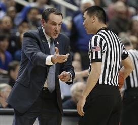 Mike Krzyzewski, arguing a call with official Jeff Pon during the Elon game at the Greensboro Coliseum, coaches Duke tonight before back surgery Friday.