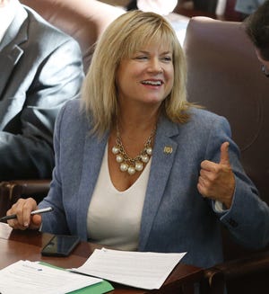 Oklahoma state Rep. Leslie Osborn, R-Mustang, gestures as she talks with a colleague on the House floor in Oklahoma City on Wednesday, Jan. 4, 2017. Oklahoma's Department of Education says it needs $221 million more in funding for the next school year just to keep pace with student growth. AP Photo/Sue Ogrocki