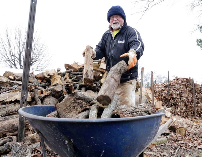 James Hanna collects wood for the fireplace Tuesday, Jan 03, 2017, before a cold front moves through the area that is expected to drop overnight tempatures into the teens. JAMIE MITCHELL/TIMES RECORD