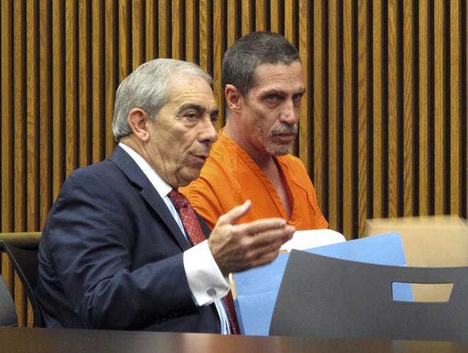 Bobby Hernandez, right, listens to defense attorney Ralph DeFranco, left, in Cuyahoga County Common Pleas Court in Cleveland on Dec. 1, 2015. Hernandez, imprisoned in Ohio for abducting his then-5-year-old son from the boy's mother in Alabama in 2002 and settling in Cleveland using new identities, is seeking early release from a four-year prison sentence he received in April 2016 after pleading guilty to kidnapping and other charges. (AP Photo/Kantele Franko, File)