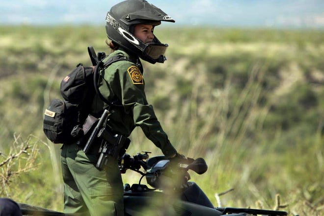 A U.S. Border patrol agent scans the border near Tucson, Arizona.