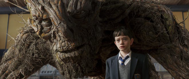 Lewis MacDougall appears with The Monster, voiced and performed by Liam Neeson, in a scene from "A Monster Calls." (Apaches Entertainment)