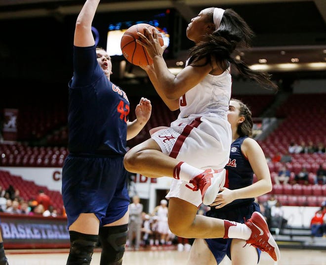 Alabama's Meoshonti Knight (15) goes up for a shot in front of Ole Miss defender Shelby Gibson (42) in the first half at Coleman Coliseum on Thursday.