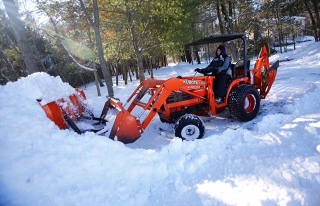 On Sunday, Eric Nelson of Prospect Street uses his tractor to clear his driveway.