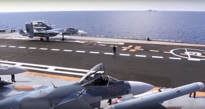 Russian Su-33 fighter jets stand on the flight deck of the Admiral Kuznetsov aircraft carrier in the eastern Mediterranean Sea. Russia says it is withdrawing the carrier and some other warships from the waters off Syria as the first step in drawing down forces in Syria. AP FILE