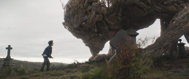 Conor (Lewis MacDougall) has some differences a monster tree (voiced and performed by Liam Neeson). (Focus Features)