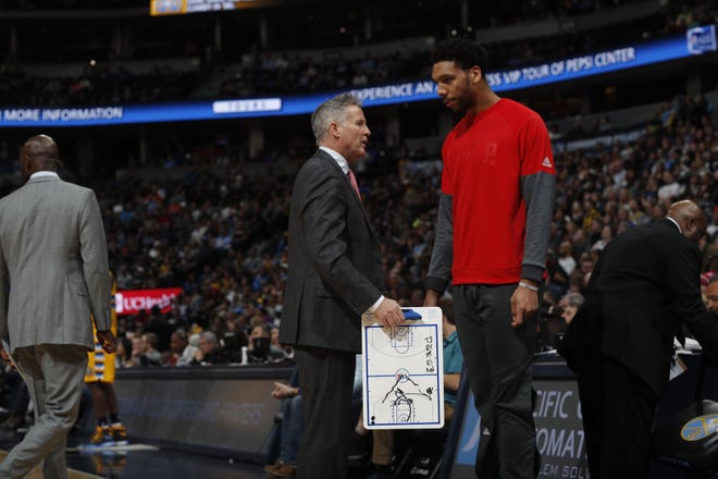 (File) Sixers head coach Brett Brown confers with second-year center Jahlil Okafor during a game earlier this season.