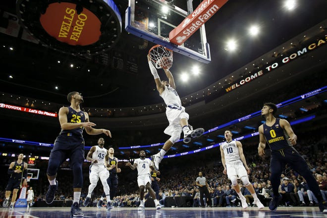 Villanova's Josh Hart dunk the ball during the second half of an NCAA college basketball game against Marquette on Saturday, Jan. 7, 2017, in Philadelphia.