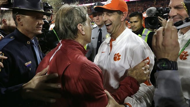 Clemson coach Dabo Swinney (right) congratulates Alabama’s Nick Saban after the Crimson ?Tide defeated the Tigers 45-40 in last year’s championship game. (AP Photo/David J. Phillip, File)