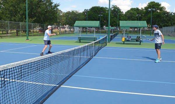 Jack Ledbetter, left, a junior at Southside High School and Woody Woodring a junior at Greenwood High School warm up on the resurfaced courts at the Creekmore Tennis Center on Wednesday, June 29, 2016. TIMES RECORD FILE PHOTO