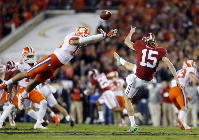 Clemson's Tanner Muse, a Belmont native and former standout at South Point High School, partially blocks the punt of Alabama's JK Scott during the first half of the NCAA college football playoff championship game Monday, Jan. 9, 2017, in Tampa, Fla. (AP Photo/John Bazemore)