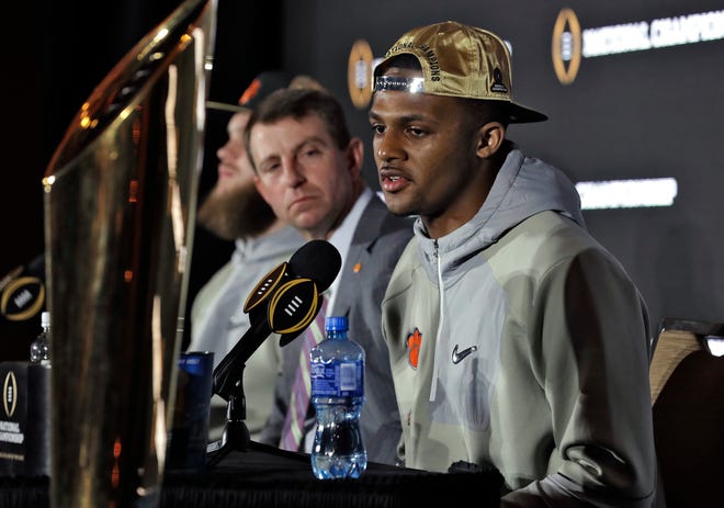Clemson quarterback Deshaun Watson, right, answers a question during an NCAA college football news conference Tuesday, Jan. 10, 2017, in Tampa, Fla. Clemson defeated Alabama 35-31 in the College Football Playoff National Championship Game the night before. Watson was the offensive player of the game. Looking on at left is head coach Dabo Swinney. (AP Photo/Chris O'Meara)