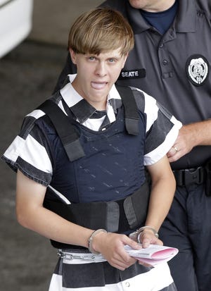 In this Thursday, June 18, 2015 file photo, convicted shooter Dylann Roof is escorted from the Cleveland County Courthouse in Shelby, N.C. A federal jury Tuesdsay sentenced Roof to death for the killing of nine congregants at Emanuel AME Church. ASSOCIATED PRESS FILE PHOTO/CHUCK BURTON