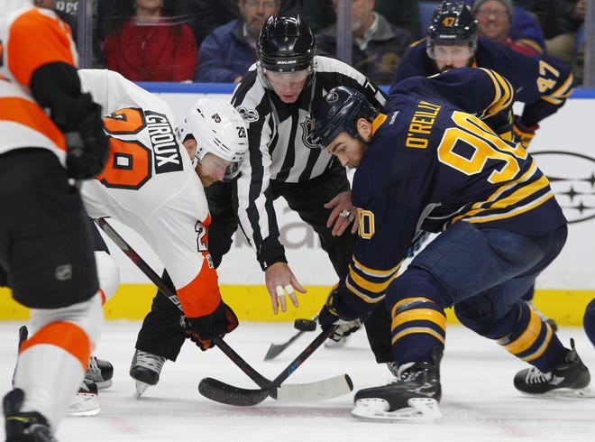 Buffalo Sabres' Ryan O'Reilly (90) and Philadelphia Flyers' Claude Giroux face off during the second period of Tuesday night's game. (AP Photo/Jeffrey T. Barnes)