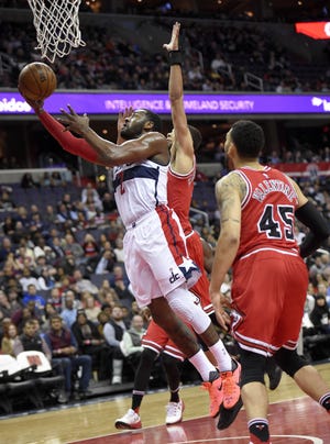 Washington's John Wall (2) goes to the basket against Chicago's Michael Carter-Williams, back, and Denzel Valentine during the Wizards' victory over the Bulls Tuesday night in Washington, D.C. NICK WASS/THE ASSOCIATED PRESS
