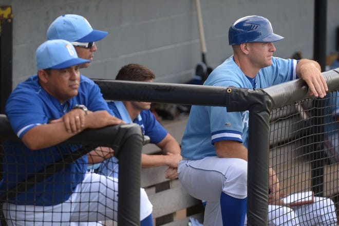 Scott Thorman, right, looks on from the dugout during a 2016 game as manager of the Burlington Royals. Hitting coach Jesus Azuaje is at the far left.