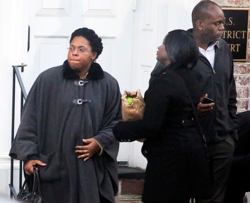 Jennifer Pinckney, left, widow of Rev. Clementa Pinckney, and Johnette Martinez leave Federal Court in Charleston Tuesday, Jan. 10, 2017, after a jury sentenced Dylann Roof to death for fatally shooting nine black church members during a Bible study session, becoming the first person ordered executed for a federal hate crime. (Brad Nettles/The Post And Courier via AP)