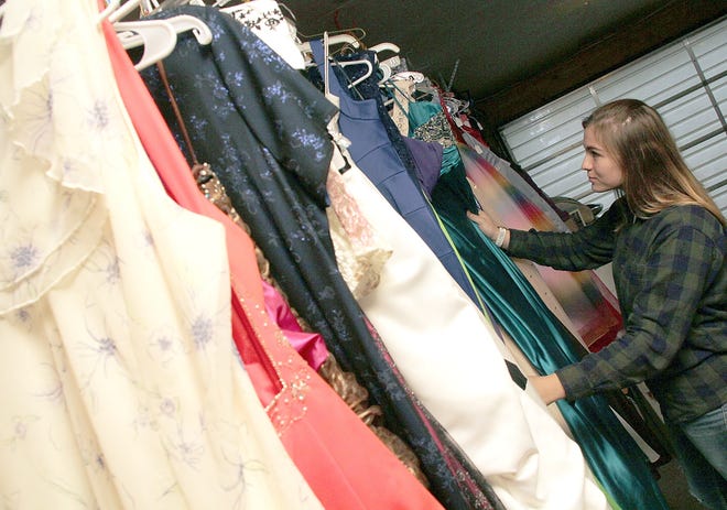 Litchfield High School junior Allie Vanous looks through a collection of used formal dresses that will be for sale at the school on Saturday. The sale, which is open to the public is from 8 a.m. to 2 p.m.

ANDY BARRAND PHOTO