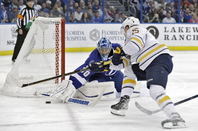 Tampa Bay Lightning goalie Ben Bishop (30) makes the save on a shot by Buffalo Sabres center Jack Eichel (15) during the first period in Tampa. CHRIS O'MEARA/THE ASSOCIATED PRESS