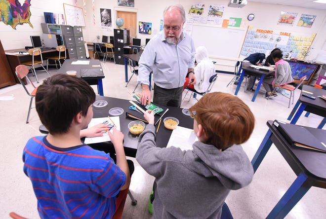 Chris Moore works with students in his class at the J.C. Roe Center in New Hanover County. KEN BLEVINS/STARNEWS PHOTO