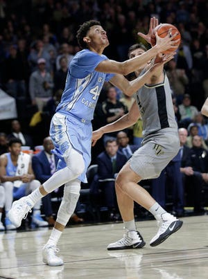 North Carolina's Justin Jackson, left, drives past Wake Forest's Dinos Mitoglou during the second half Wednesday night.