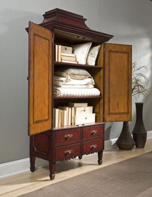 A great place to store out-of-season clothes or extra bedding is an armoire that sits in your living room.