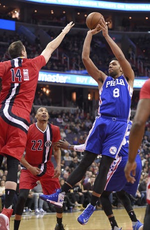(File) The 76ers' Jahlil Okafor (8) goes up for a shot over the Wizards' Jason Smith (14) during a January 2017 game in Washington.