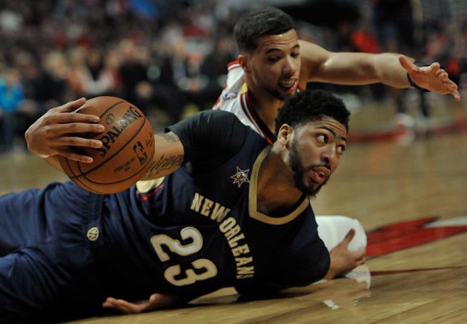 New Orleans Pelicans' Anthony Davis (23) looks to pass after battling Chicago Bulls' Michael Carter-Williams (7) for the ball during the first half of an NBA basketball game Saturday, Jan. 14, 2017, in Chicago. (AP Photo/Paul Beaty)
